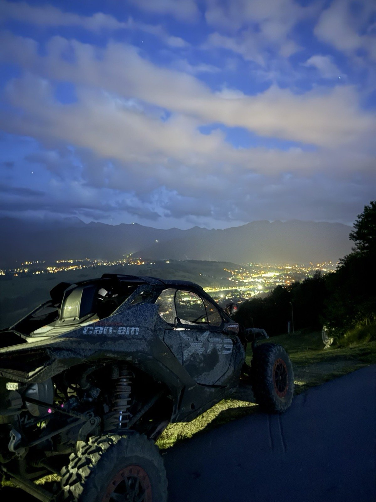 A Maverick buggy at dusk above the lights of Zakopane